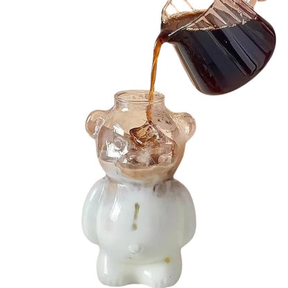 COMFORTH Adorable bear-shaped glass with clear top and opaque white base, filled with ice and coffee.