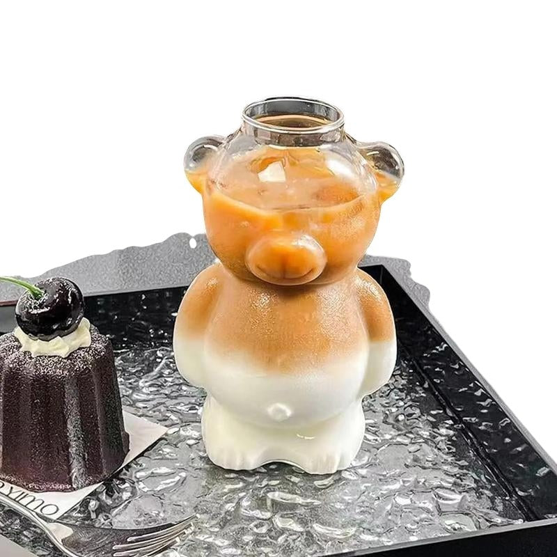 COMFORTH Adorable bear-shaped glass with straw, clear with frosted white base, holding iced coffee.
