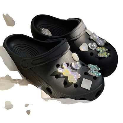 COMFORTH black clog shoes with iridescent bunny, heart, and butterfly charms. Waterproof material.