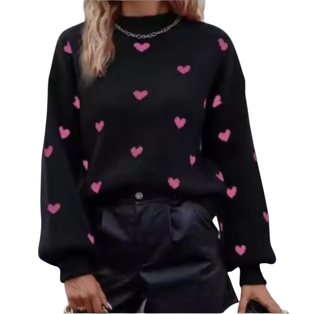 COMFORTH black knit sweater with pink heart pattern, long sleeves, crew neck, and ribbed cuffs and hem.