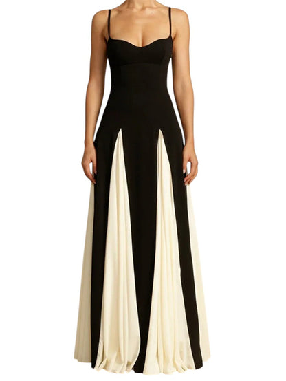 COMFORTH black and ivory evening gown with sweetheart neckline, spaghetti straps, and flowing paneled skirt. Floor-length.