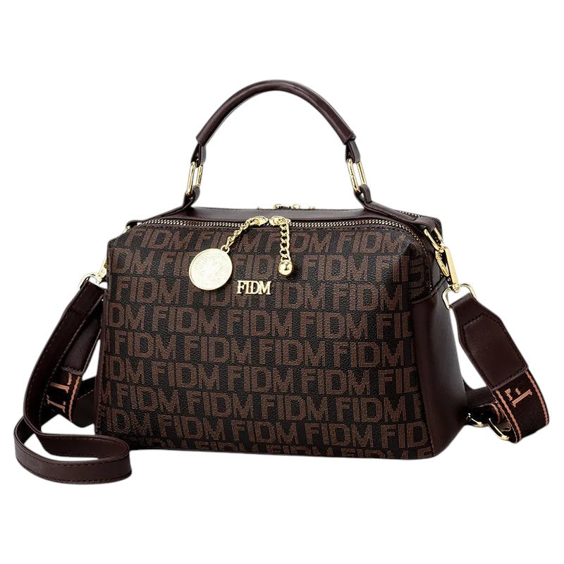 COMFORTH monogram satchel handbag in brown faux leather with gold-tone hardware and decorative charm.