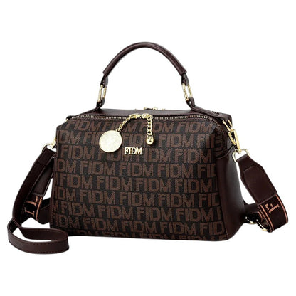 COMFORTH monogram satchel handbag in brown faux leather with gold-tone hardware and decorative charm.
