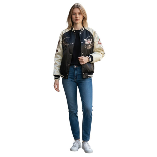 COMFORTH black and cream satin bomber jacket with floral and mythical creature embroidery. Model wears jeans and white sneakers.