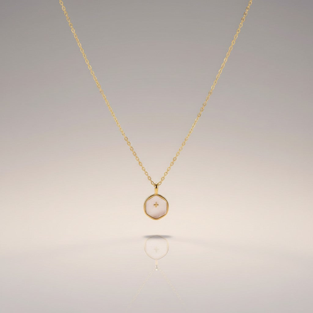 COMFORTH 14K gold-plated necklace with a creamy white, irregular-shaped pendant featuring a subtle cross design. Adjustable chain.