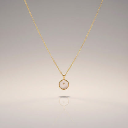 COMFORTH 14K gold-plated necklace with a creamy white, irregular-shaped pendant featuring a subtle cross design. Adjustable chain.