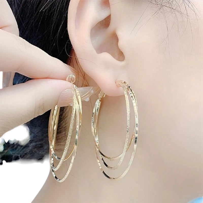 COMFORTH Gold multi-layered hoop earrings with textured finish. Lightweight metal, elegant design.