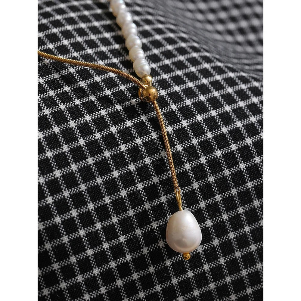 COMFORTH gold chain necklace with freshwater pearls, featuring a delicate snake chain and a lariat-style baroque pearl drop.