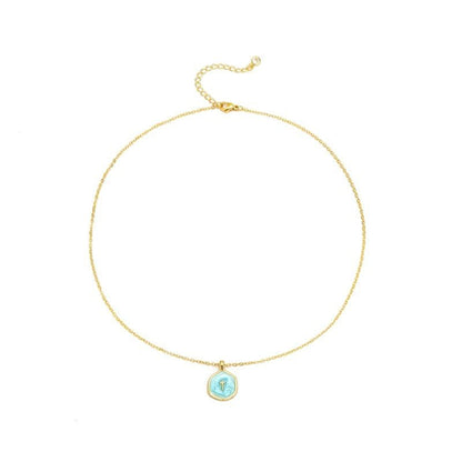 COMFORTH 14K gold plated necklace with a light blue irregular pendant featuring a subtle cross design. Adjustable chain.