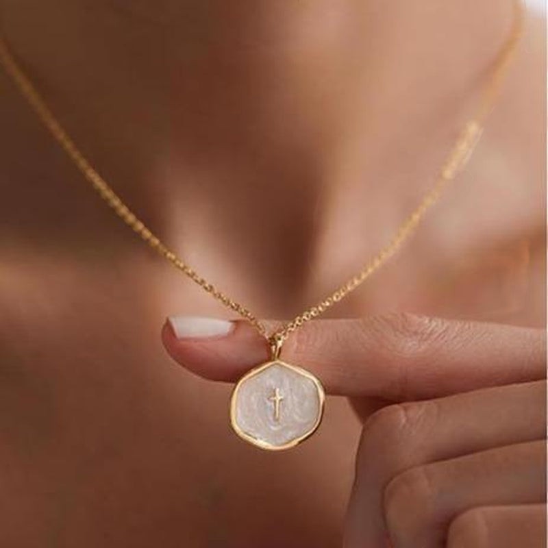 COMFORTH gold plated necklace with a unique irregular pendant featuring a subtle cross on a creamy white inlay. Adjustable chain.