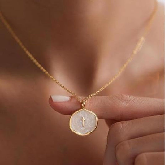 COMFORTH gold plated necklace with a unique irregular pendant featuring a subtle cross on a creamy white inlay. Adjustable chain.