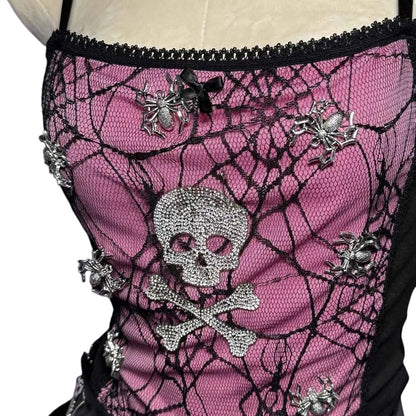 COMFORTHot pink lace corset top with black spider web overlay, rhinestone skull and crossbones, and spider accents. Black lace trim and bow detail.