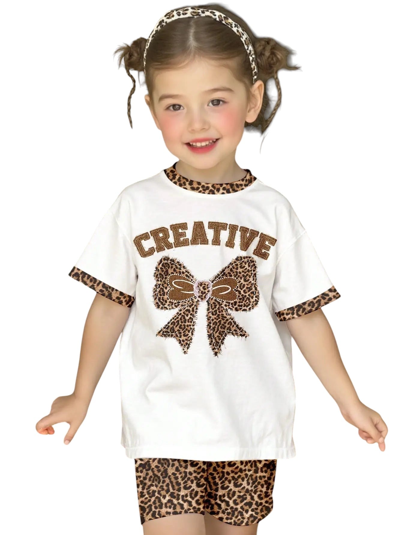 COMFORTH white t-shirt with leopard print bow graphic and matching shorts. Cotton set for kids.