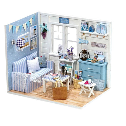 COMFORTH Miniature dollhouse kit with a coastal living room theme, featuring a blue striped sofa, white table, and beach-themed decor.