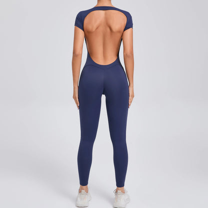 COMFORTH navy blue short sleeve full length activewear bodysuit with open back and v-shaped waistline.