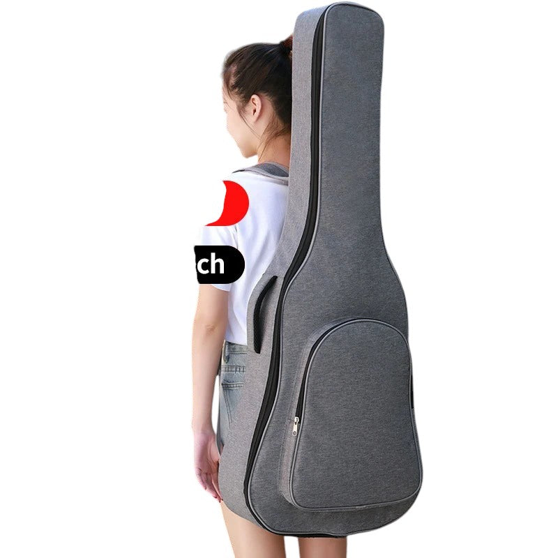 COMFORTH padded grey guitar gig bag with carrying handle and accessory pocket, worn by a woman.