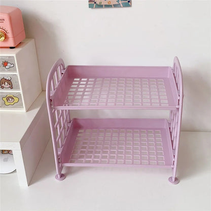 COMFORTH two-tier pink plastic desk organizer shelf with grid pattern shelves and curved sides.