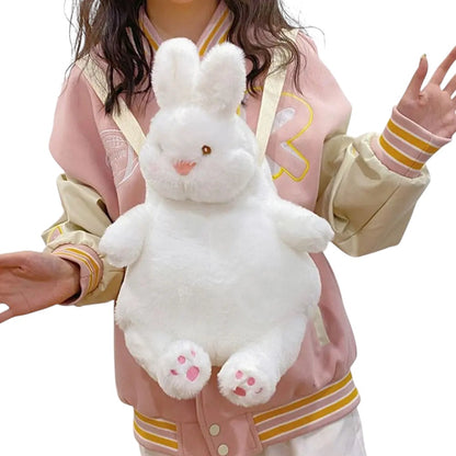 COMFORTH white plush bunny backpack with pink paw details, adjustable straps, and zipper closure. Fun accessory for kids and adults.