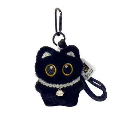 COMFORTH plush black cat keychain with pearl necklace and cloud charm. Features big yellow eyes and soft fur.