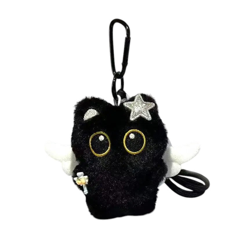 COMFORTH black plush cat keychain with white wings, star accent, and holding a flower.
