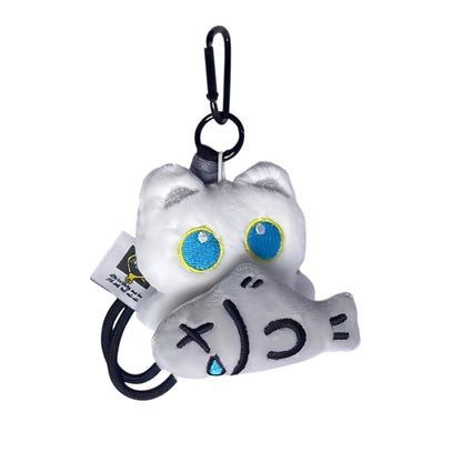 COMFORTH plush white cat charm with blue eyes holding a grey fish toy with a distressed face.