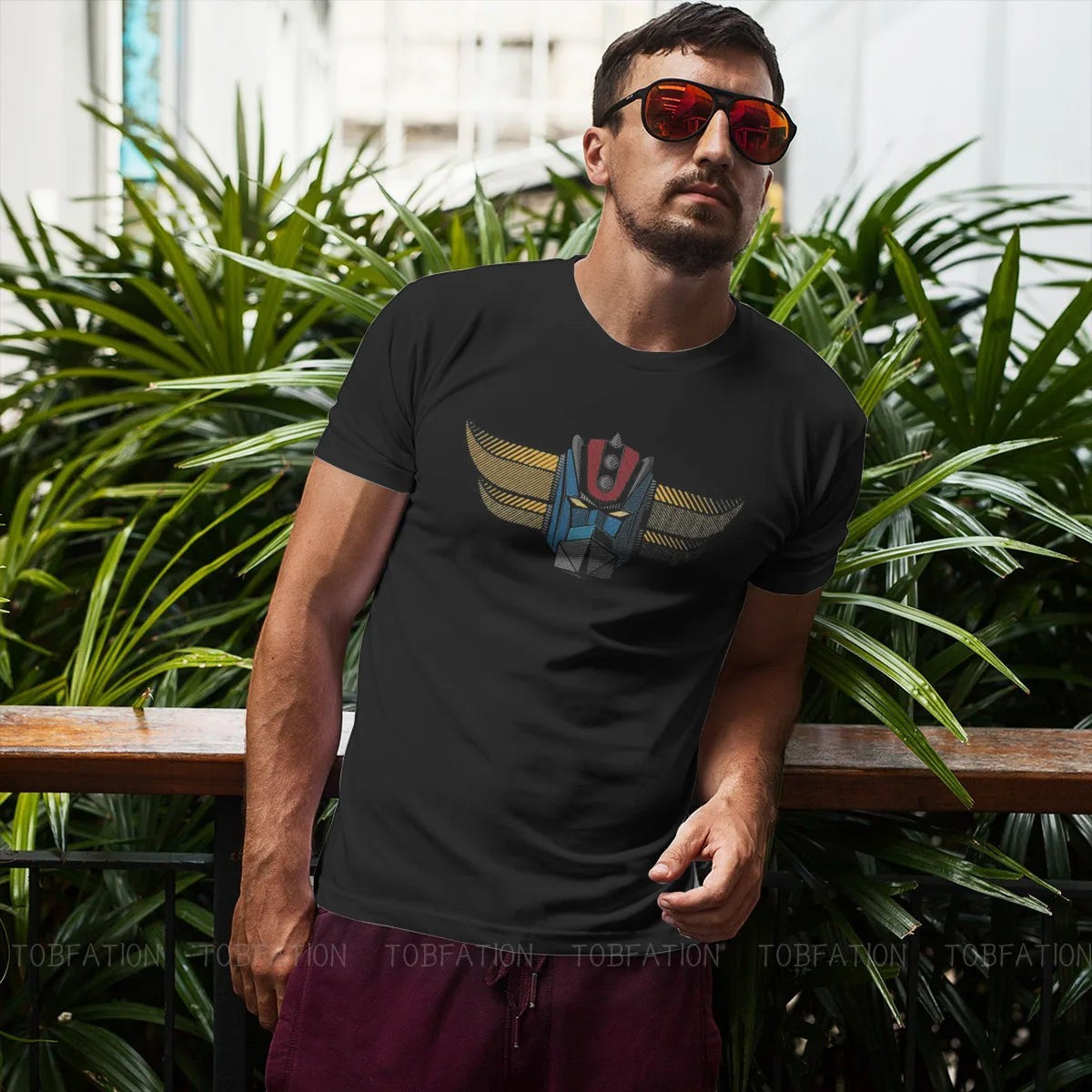 COMFORTH black cotton t-shirt with retro robot head graphic in blue, red, and yellow. Short sleeves, crew neck.