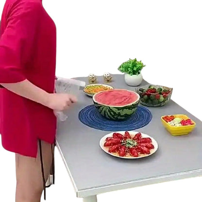 COMFORTH Reusable food storage covers sealing a watermelon half filled with smoothie, bowls of salad and fruit, and a plate of food.
