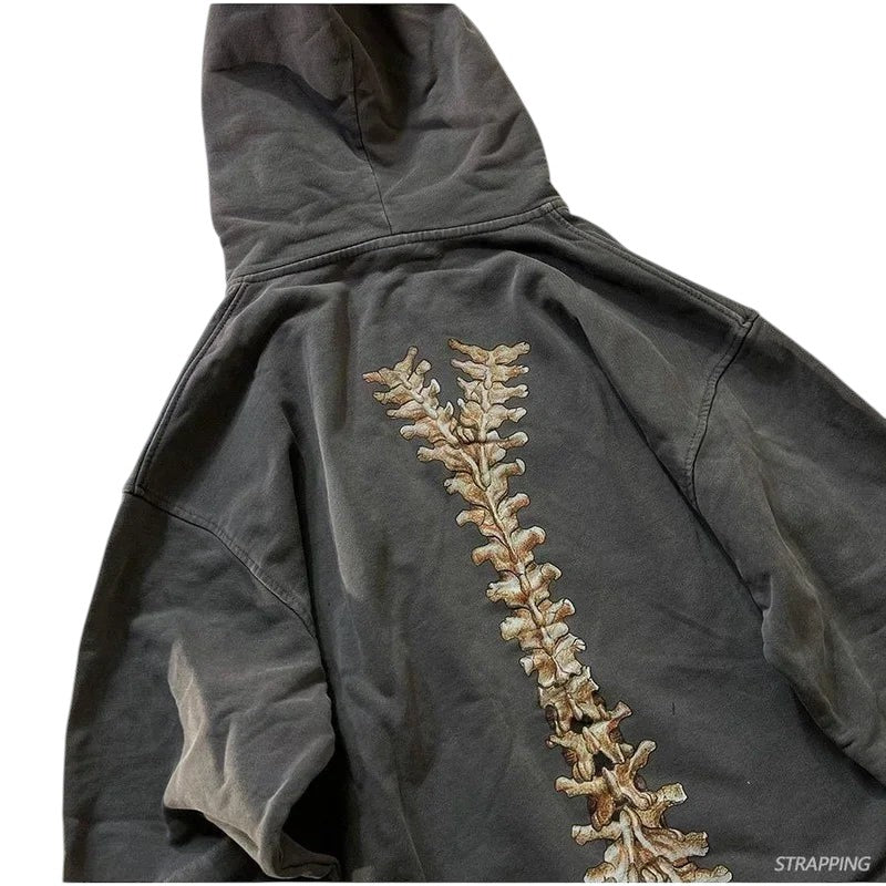 COMFORTH charcoal grey cotton blend zip-up hoodie with distressed skeleton graphic on back. Relaxed fit, drawstring hood, kangaroo pocket.