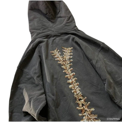 COMFORTH charcoal grey cotton blend zip-up hoodie with distressed skeleton graphic on back. Relaxed fit, drawstring hood, kangaroo pocket.