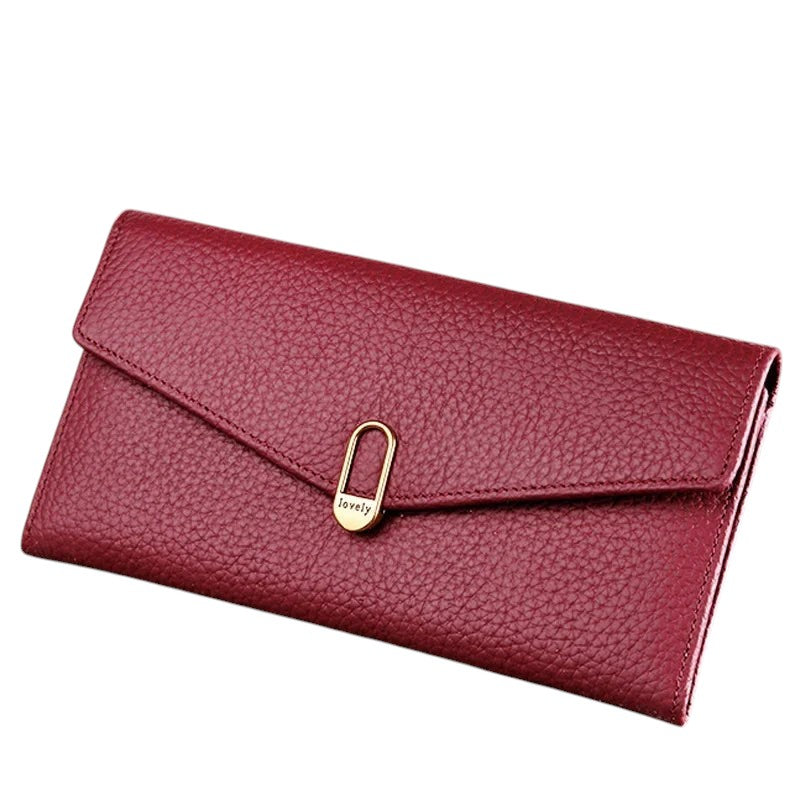 COMFORTH Textured leather envelope wallet in deep red with gold clasp and 'lovely' detail. Features multiple card slots and zippered pocket.