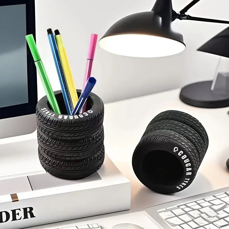 COMFORTH black tire-shaped desk organizer pen holder with realistic tread pattern holding pens and markers.
