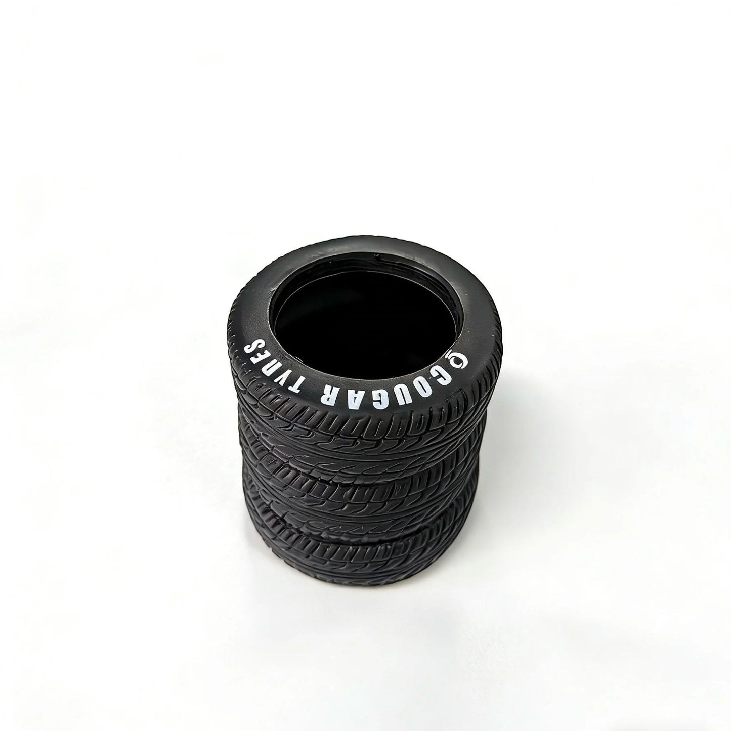 COMFORTH black tire-shaped desk organizer pen holder with realistic tread and white lettering.