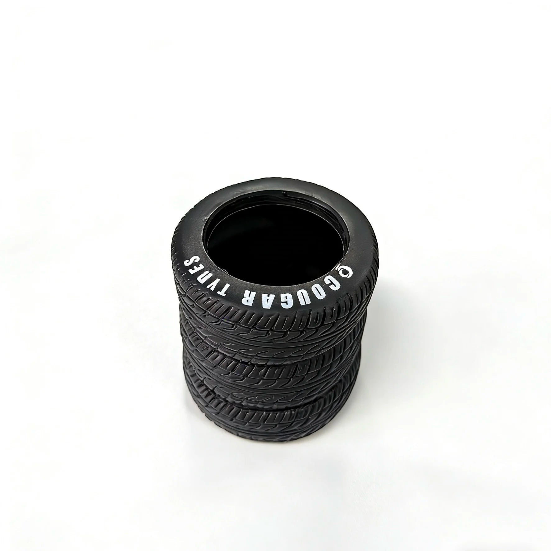 COMFORTH black tire-shaped desk organizer pen holder with realistic tread and white lettering.