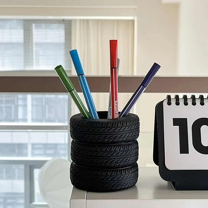COMFORTH black tire-shaped desk organizer pen holder with realistic tread pattern holding colorful markers.