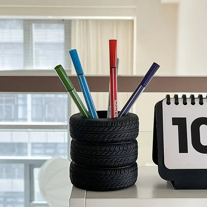 COMFORTH black tire-shaped desk organizer pen holder with realistic tread pattern holding colorful markers.