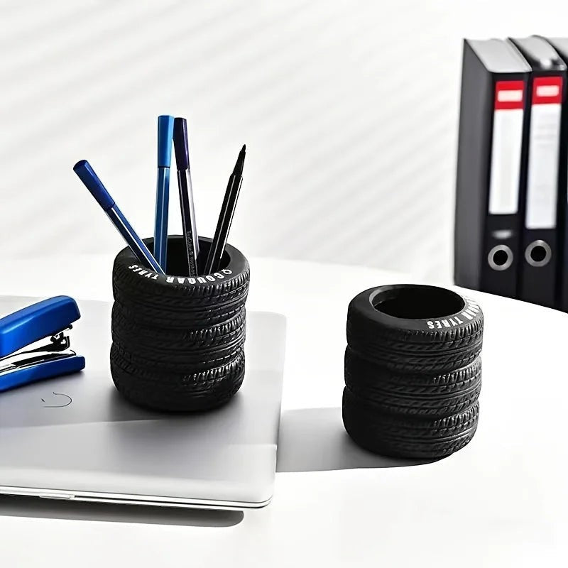 COMFORTH black tire-shaped desk organizer pen holder with realistic tread pattern, holding pens and pencils.