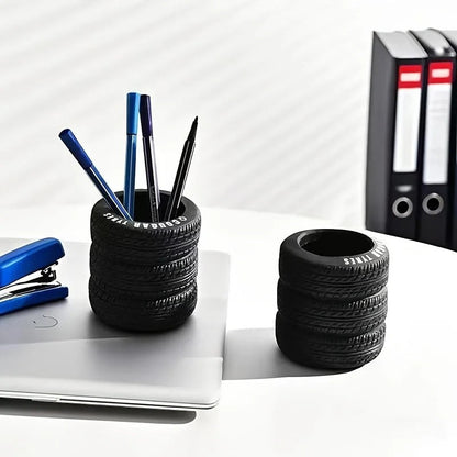 COMFORTH black tire-shaped desk organizer pen holder with realistic tread pattern, holding pens and pencils.