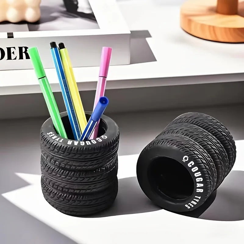 COMFORTH black tire-shaped desk organizer pen holder with realistic tread and white lettering.