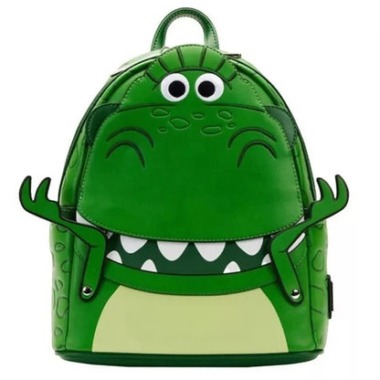 COMFORTH Toy Story Rex Dinosaur backpack in green faux leather with googly eyes and outstretched arms.