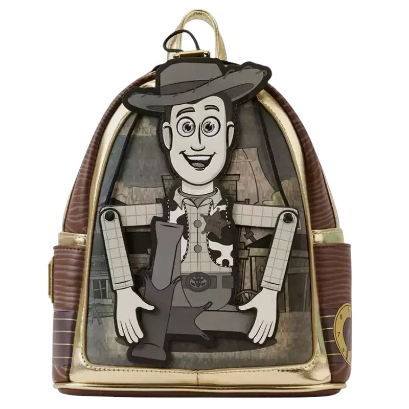 COMFORTH Toy Story Woody backpack with Pizza Planet alien design. Brown vegan leather with gold trim.