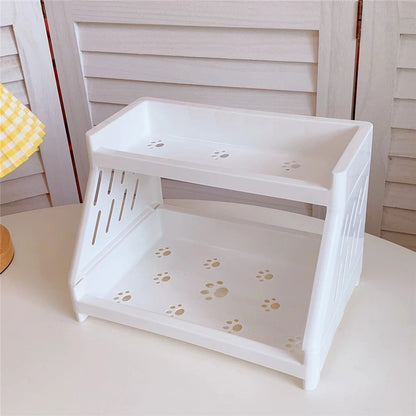 COMFORTH Two Tier Desk Organizer Shelf in white plastic with paw print cutouts. Perfect for stationery or cosmetics.