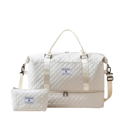COMFORTH white quilted duffel bag with matching pouch, diamond-quilted pattern, separate bottom compartment, top handles, and shoulder strap.