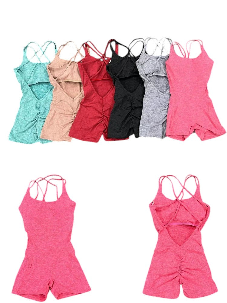COMFORTH Women's athletic bodysuit with open back, crisscross straps, and ruched shorts. Available in pink.