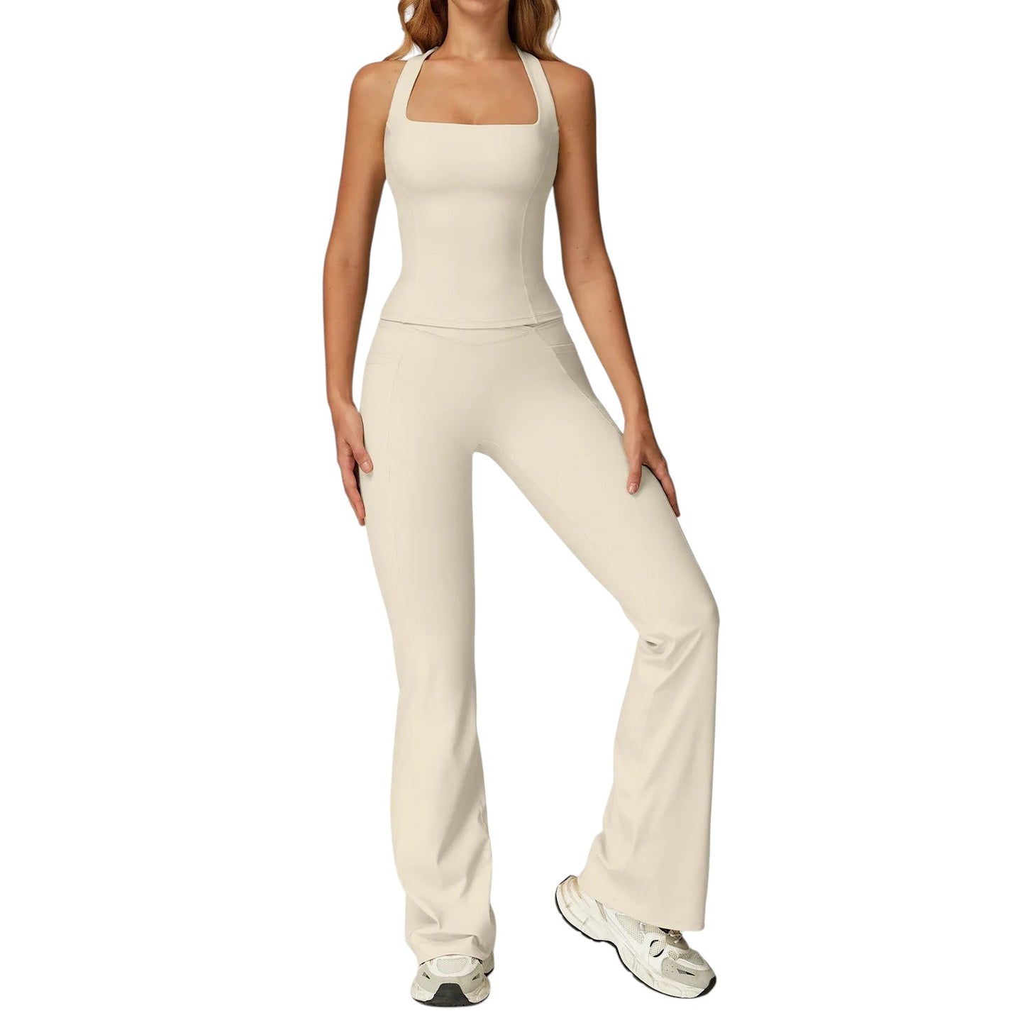 COMFORTH Women's athletic two-piece set with halter neck top and flare leggings in cream.