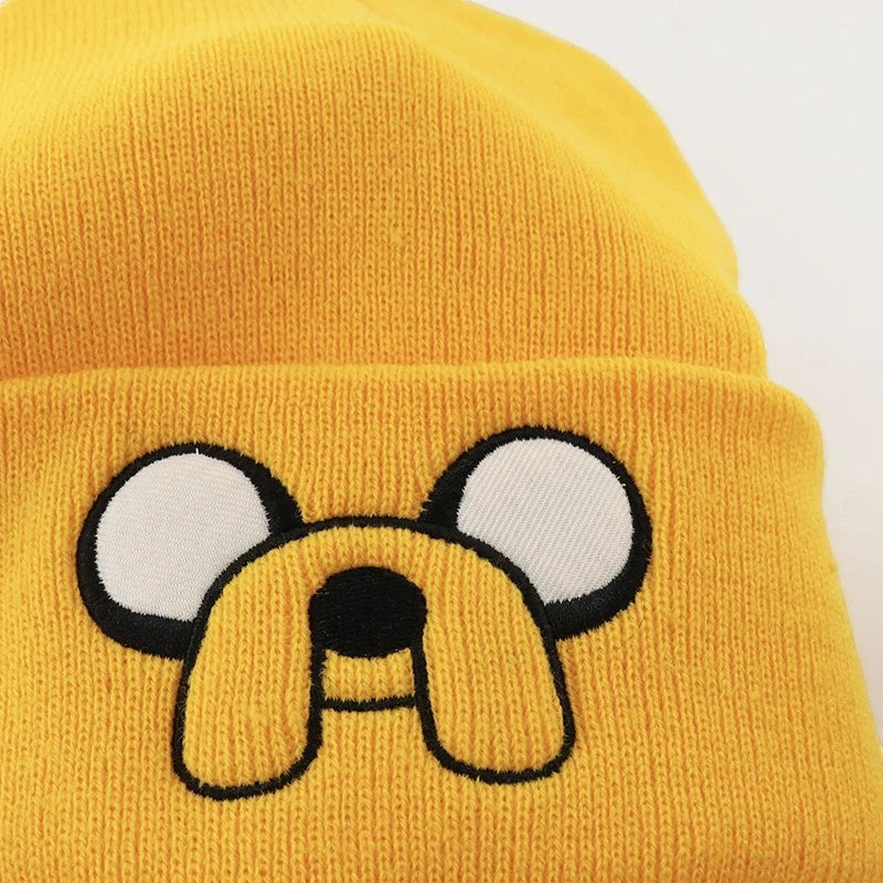 COMFORTHere yellow knit beanie hat with embroidered Jake the Dog face and floppy ears from Adventure Time.