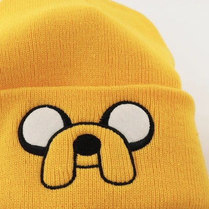 COMFORTHere yellow knit beanie hat with embroidered Jake the Dog face and floppy ears from Adventure Time.