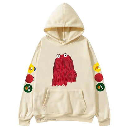 COMFORTHere cream graphic hoodie with red character on front and character icons on sleeve. Soft fabric.