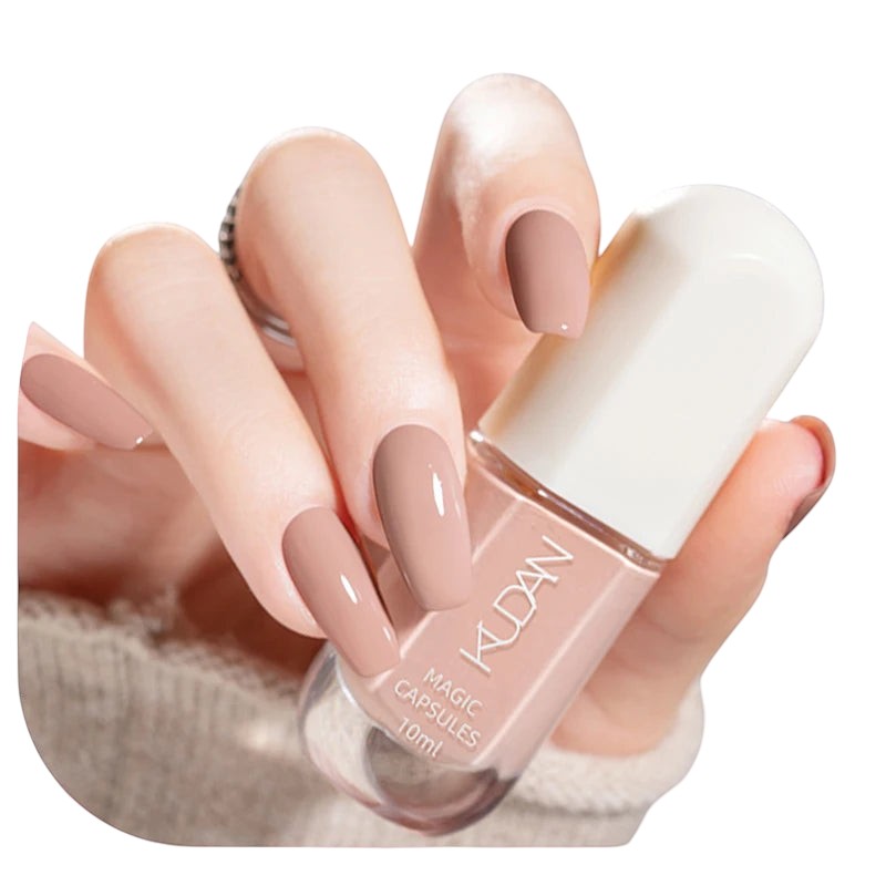 COMFORTHere's a hand with nude-colored, coffin-shaped nails holding a bottle of nude nail polish.