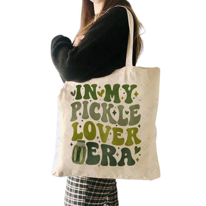 COMFORTHere In My Pickle Lover Era canvas tote bag with pickle jar graphic and green lettering.
