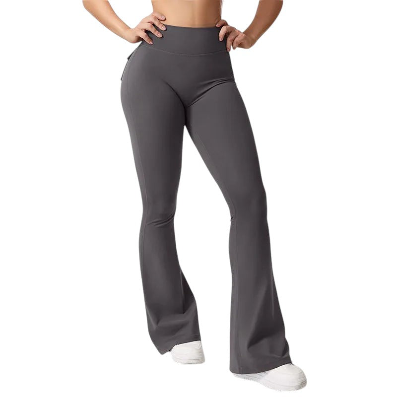 COMFORTHigh waisted dark grey flare yoga pants with pockets and ruched detailing on the back.